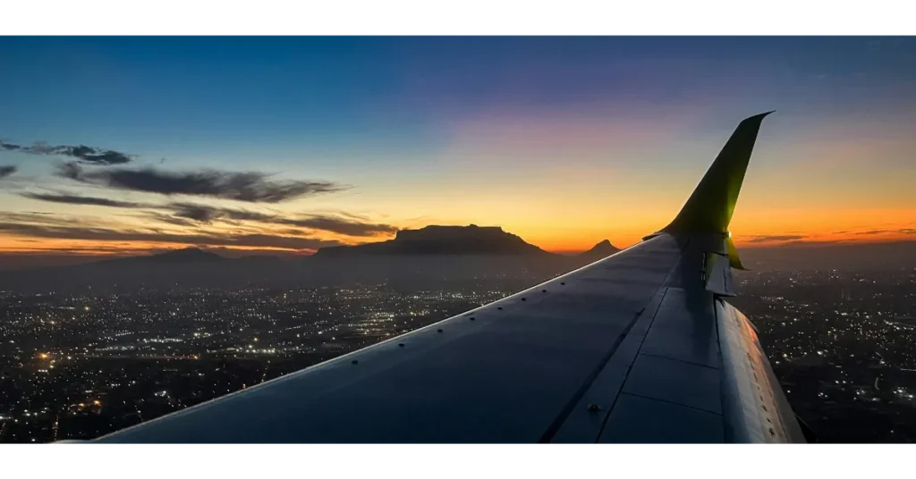 View from an airplane window during a long-haul business class flight to Africa at sunset