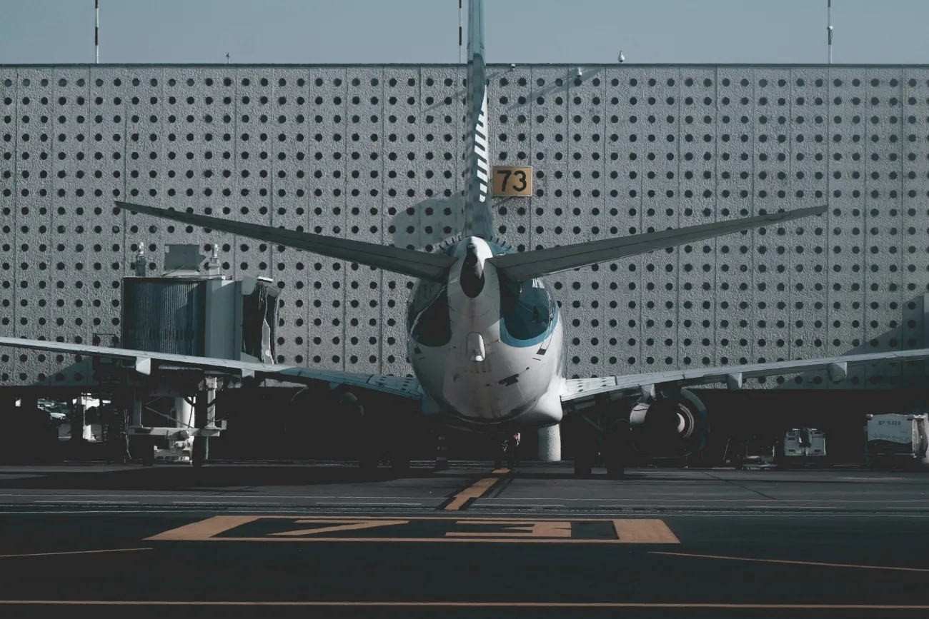 Book flights with deposit only UK – commercial aircraft at airport gate ready for departure