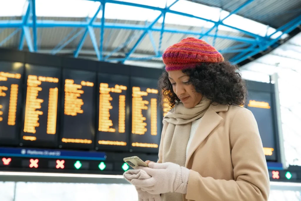 Woman booking book now pay later flights no credit check vs buy now pay later at UK airport